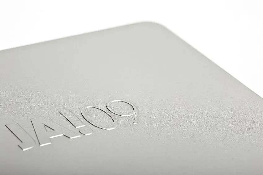 Nahaufnahme eines silbernen Objekts mit dem geprägten Text „VALOO9“ an einer Ecke.