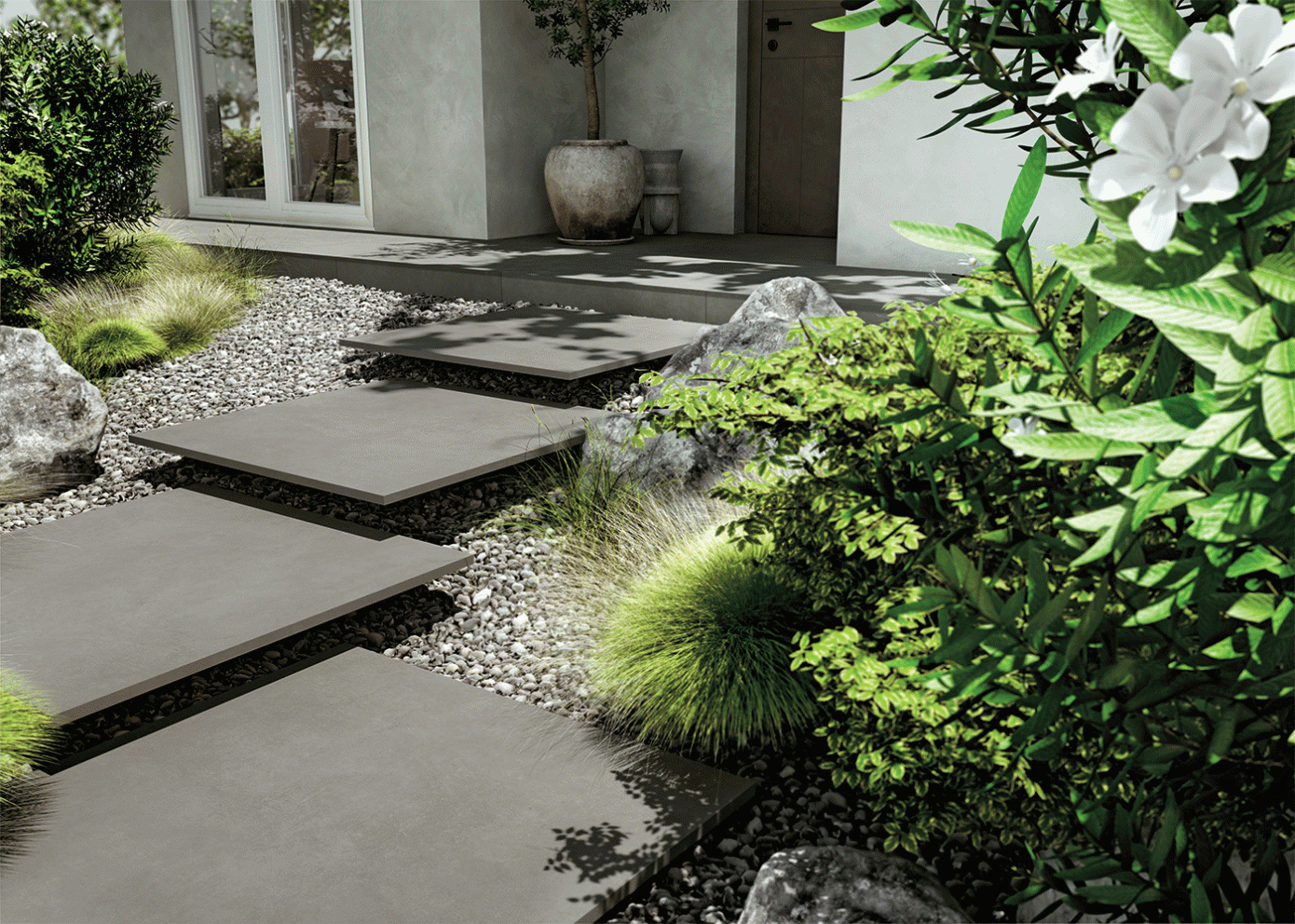 Allée de jardin moderne avec dalles, gravier et fleurs blanches près de l'entrée d'une maison
