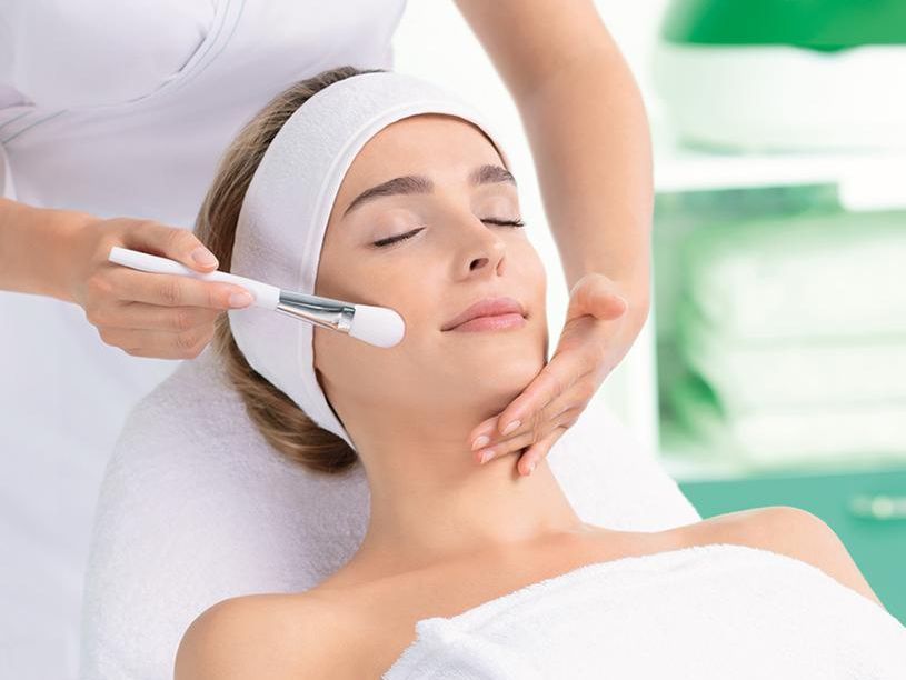 Una mujer está recibiendo un tratamiento facial en un spa.