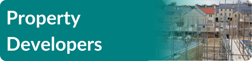 A blue sign that says property developers on it