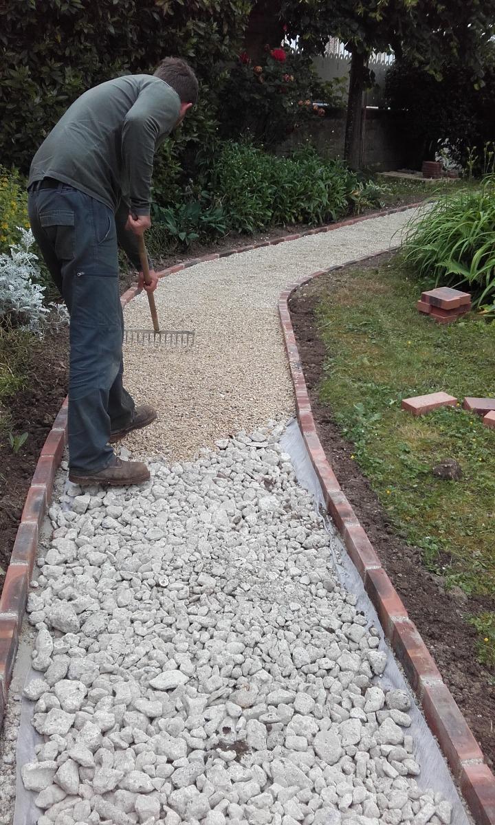 Pose de graviers dans une allée par un artisan