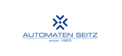 Logo für Automaten Seitz: Blaues geometrisches Symbol über dem Firmennamen und „seit 1963“ auf weißem Hintergrund.