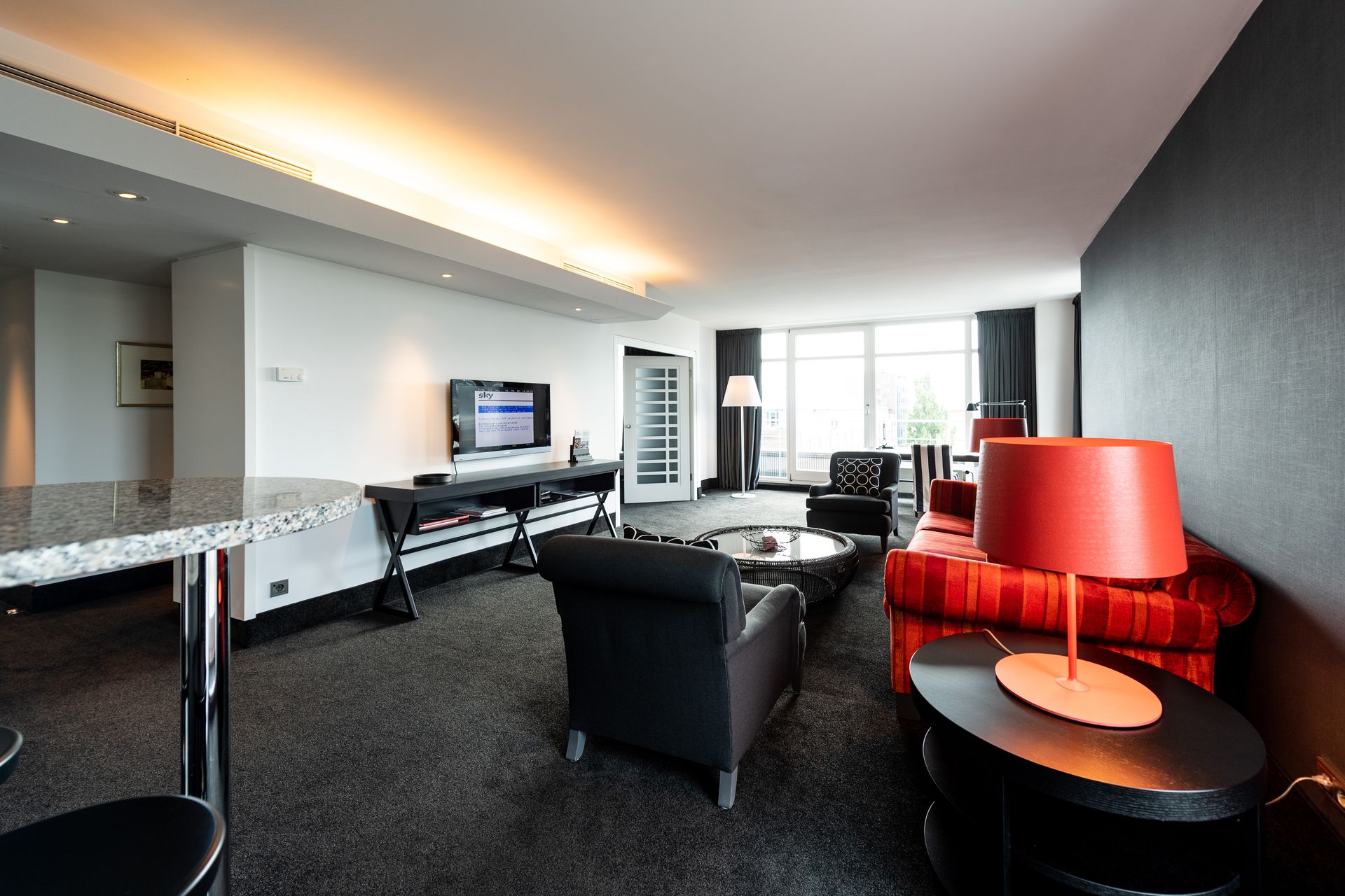 A living room filled with furniture and a television