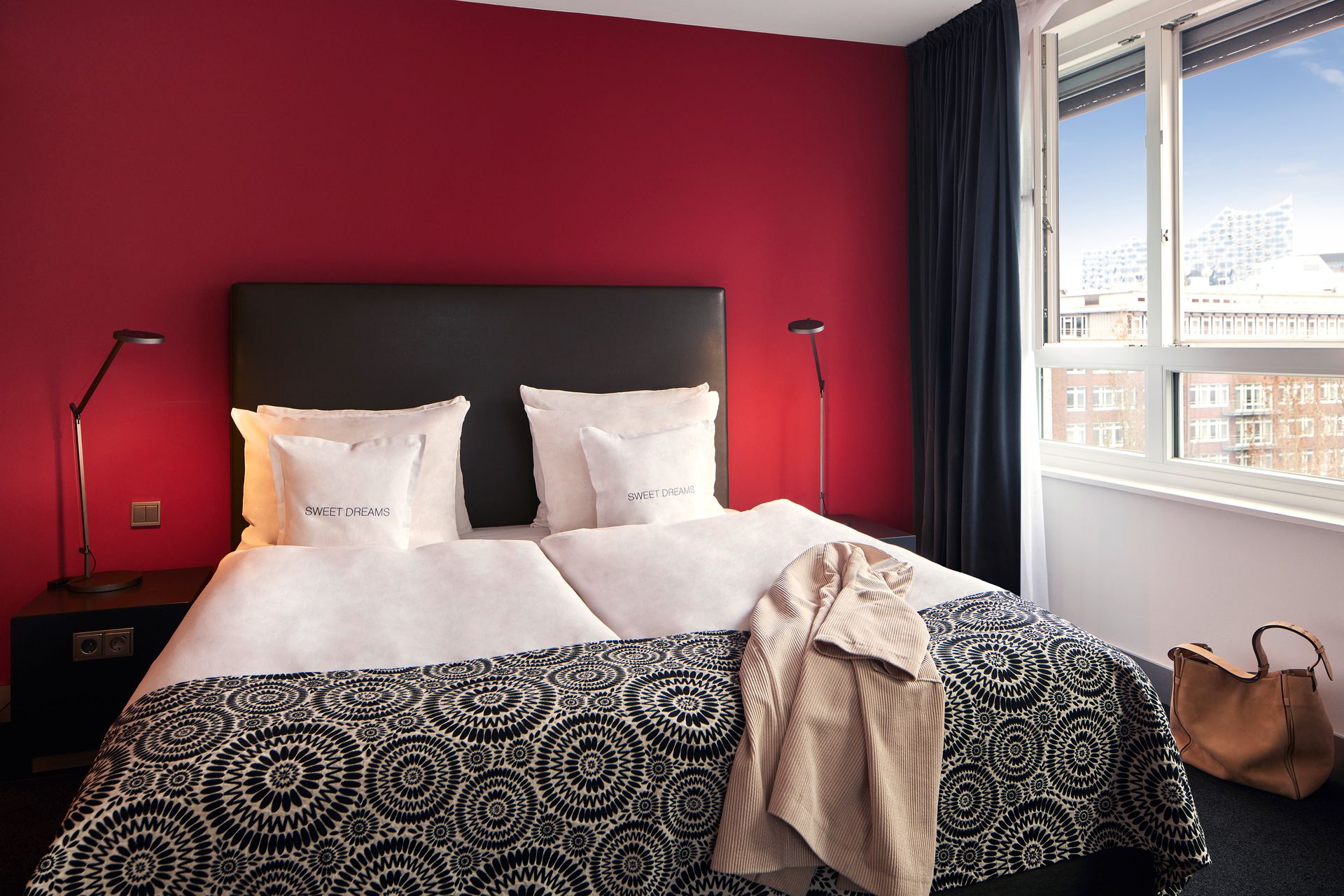 A hotel room with a bed and a window