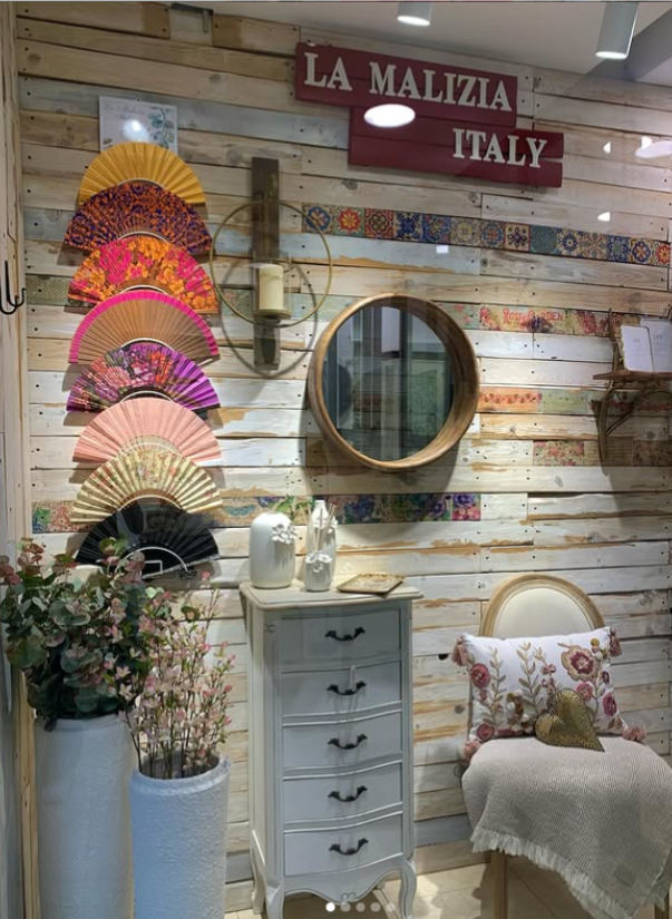 Una habitación con una pared de madera, una cómoda, una silla y un espejo.