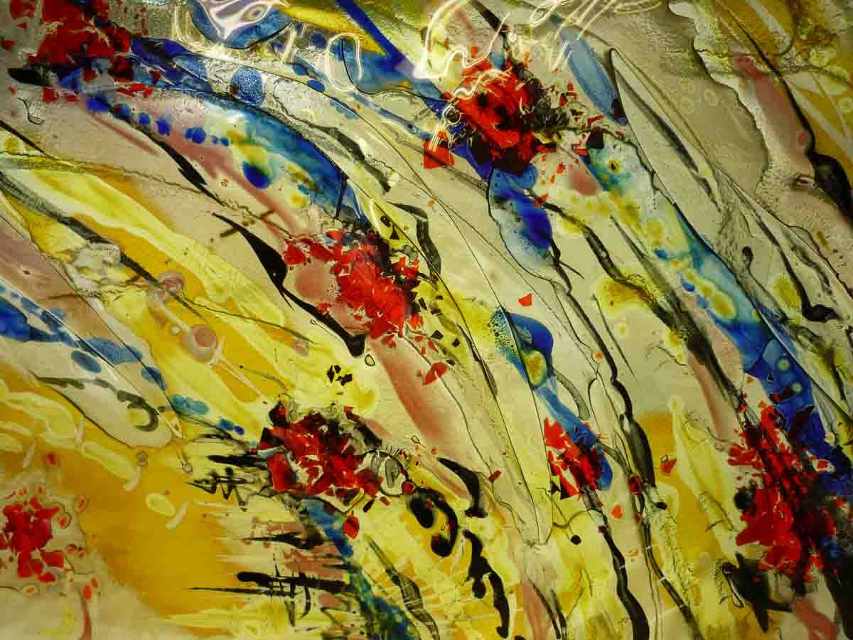 Peinture abstraite avec des éclaboussures rouges, bleues et jaunes, des lignes noires sur un fond clair texturé.