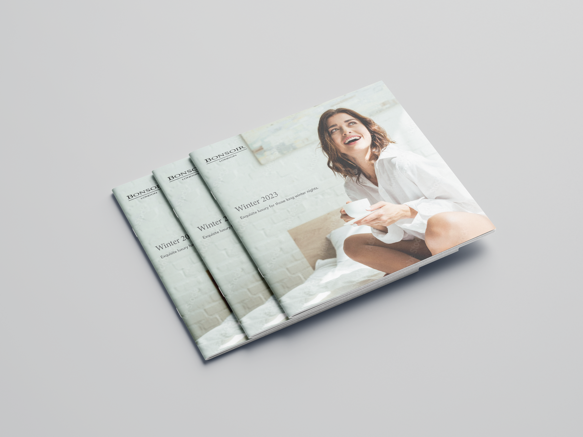 Three stacked brochures featuring a smiling person holding a white mug in a light-filled bedroom setting.