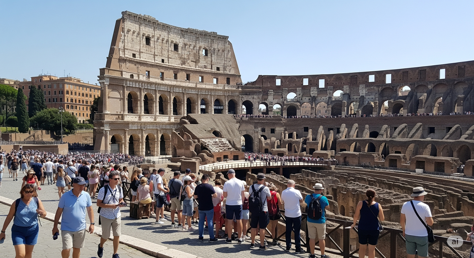 ItsSo Travel can design your perfect holiday experience A large group of people are walking in front of the colosseum in Rome.