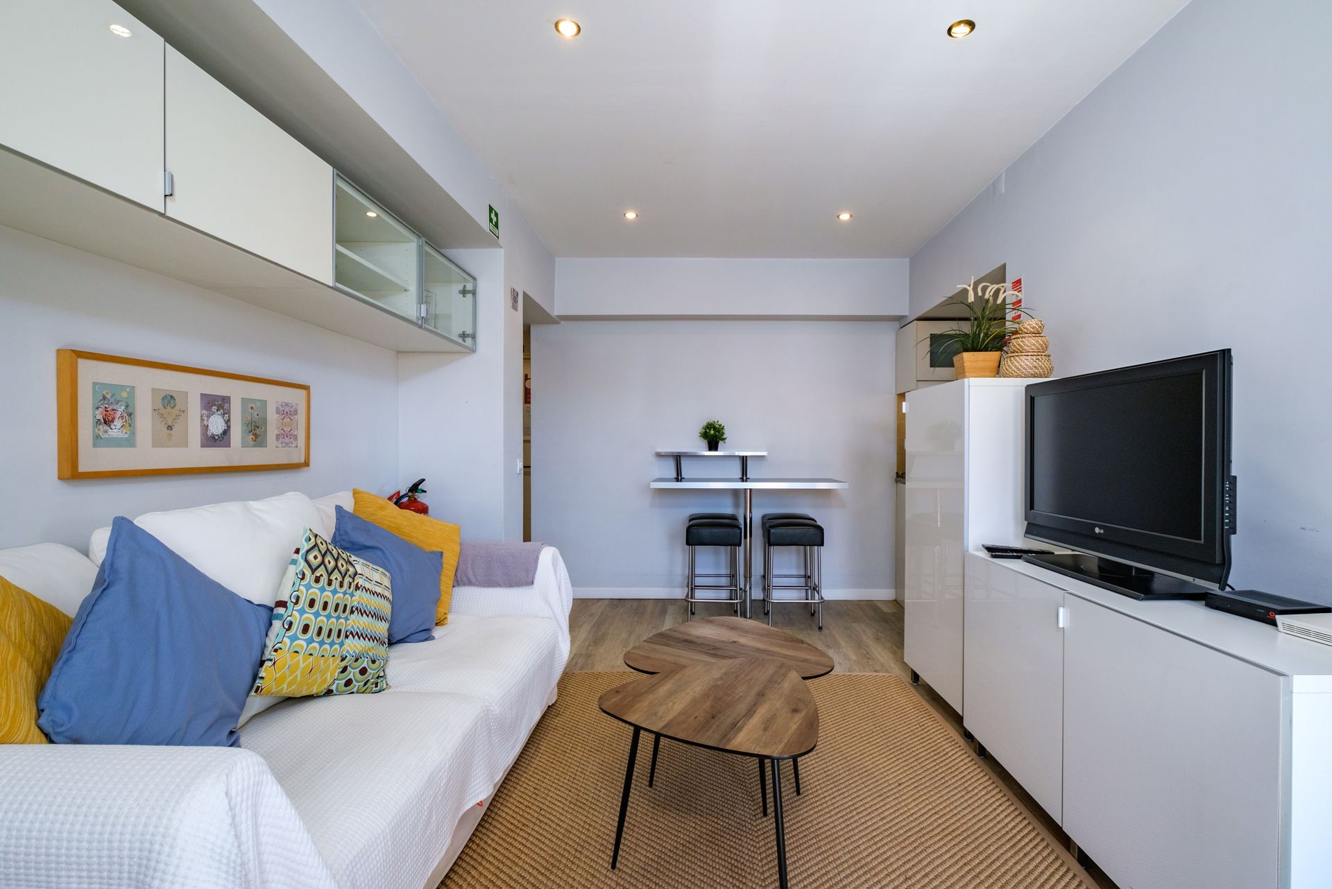 A living room with a couch , table , and television.