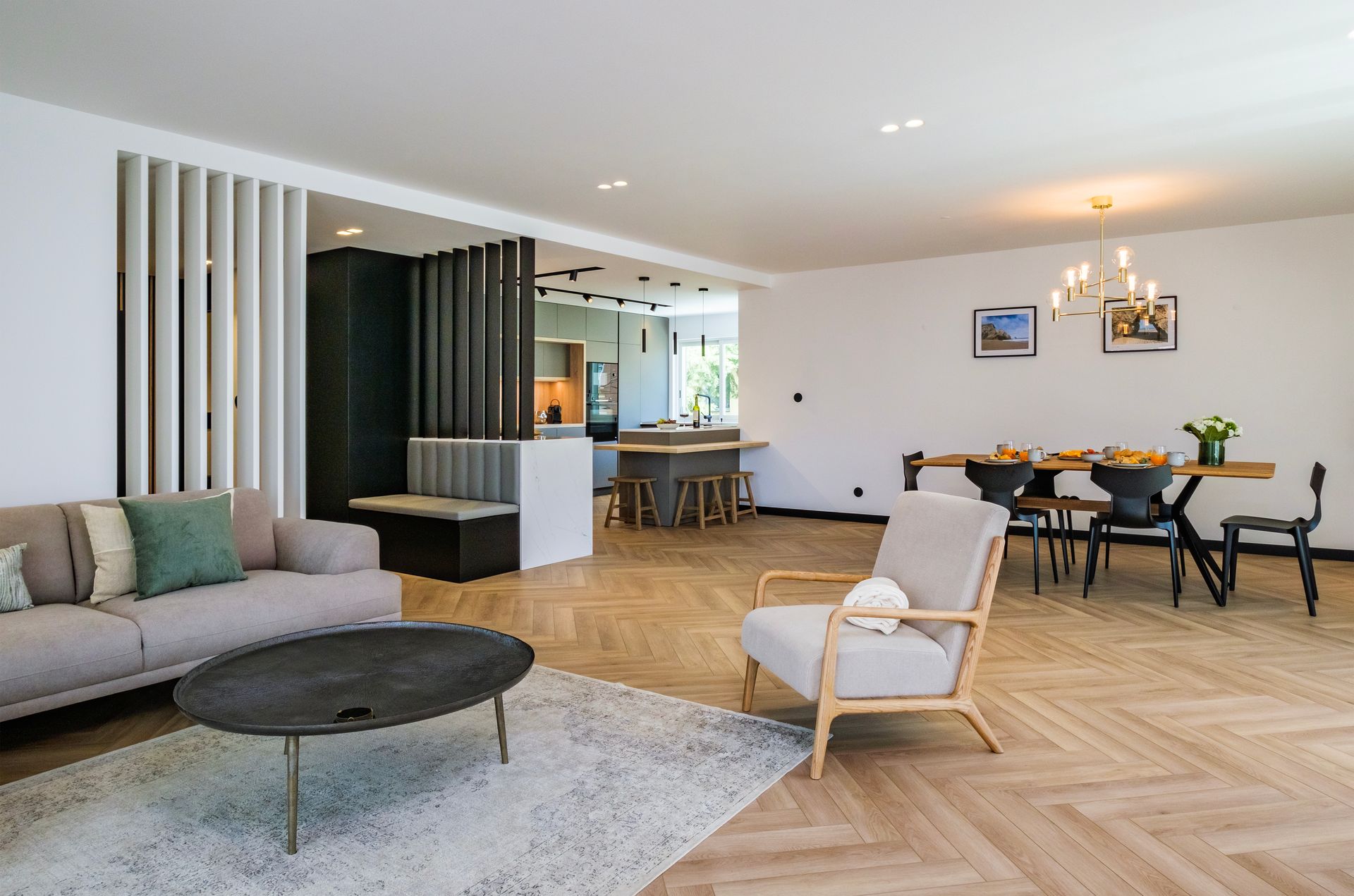 A living room with a couch , chair , coffee table and dining table.