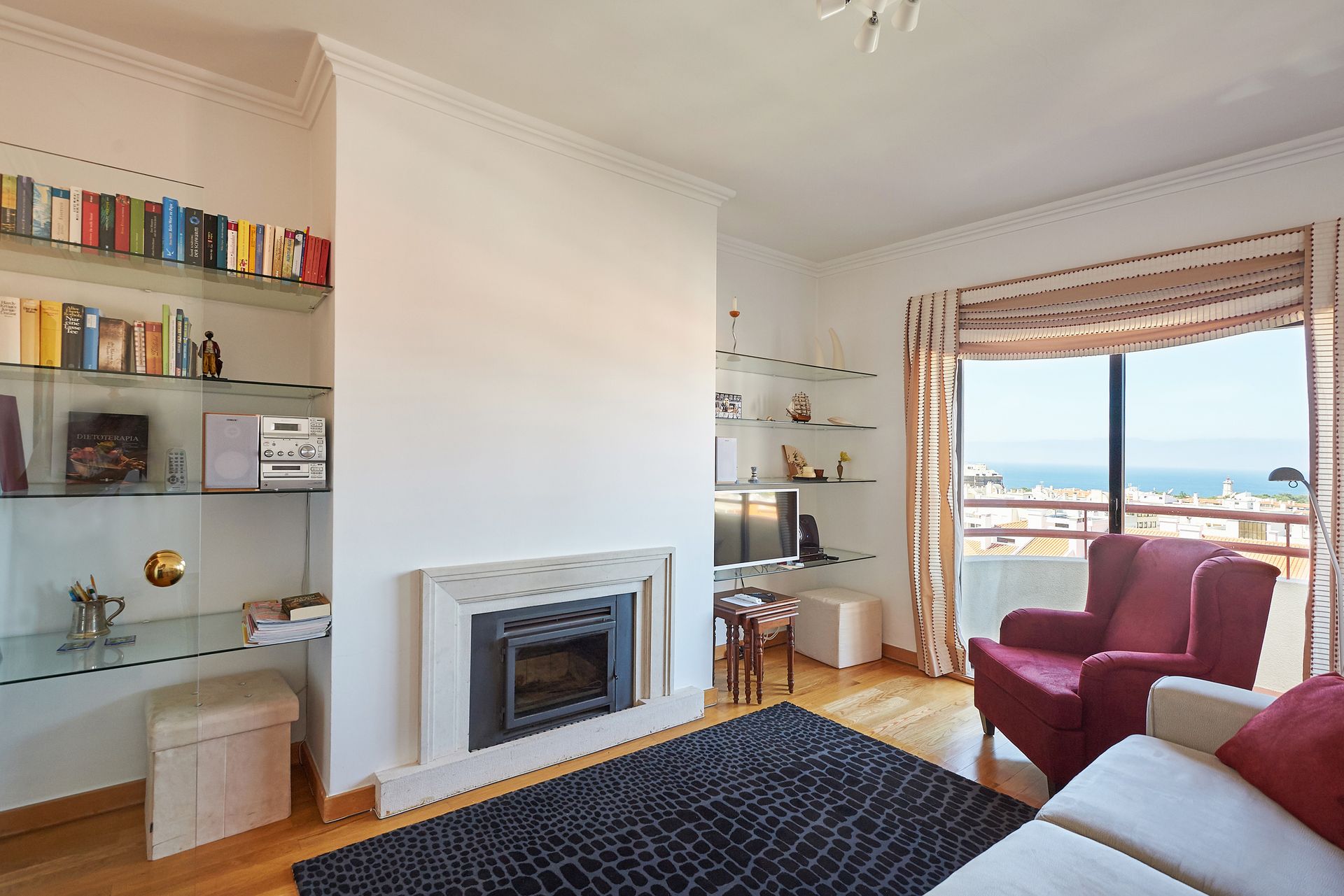 A living room with a fireplace , couch and chairs