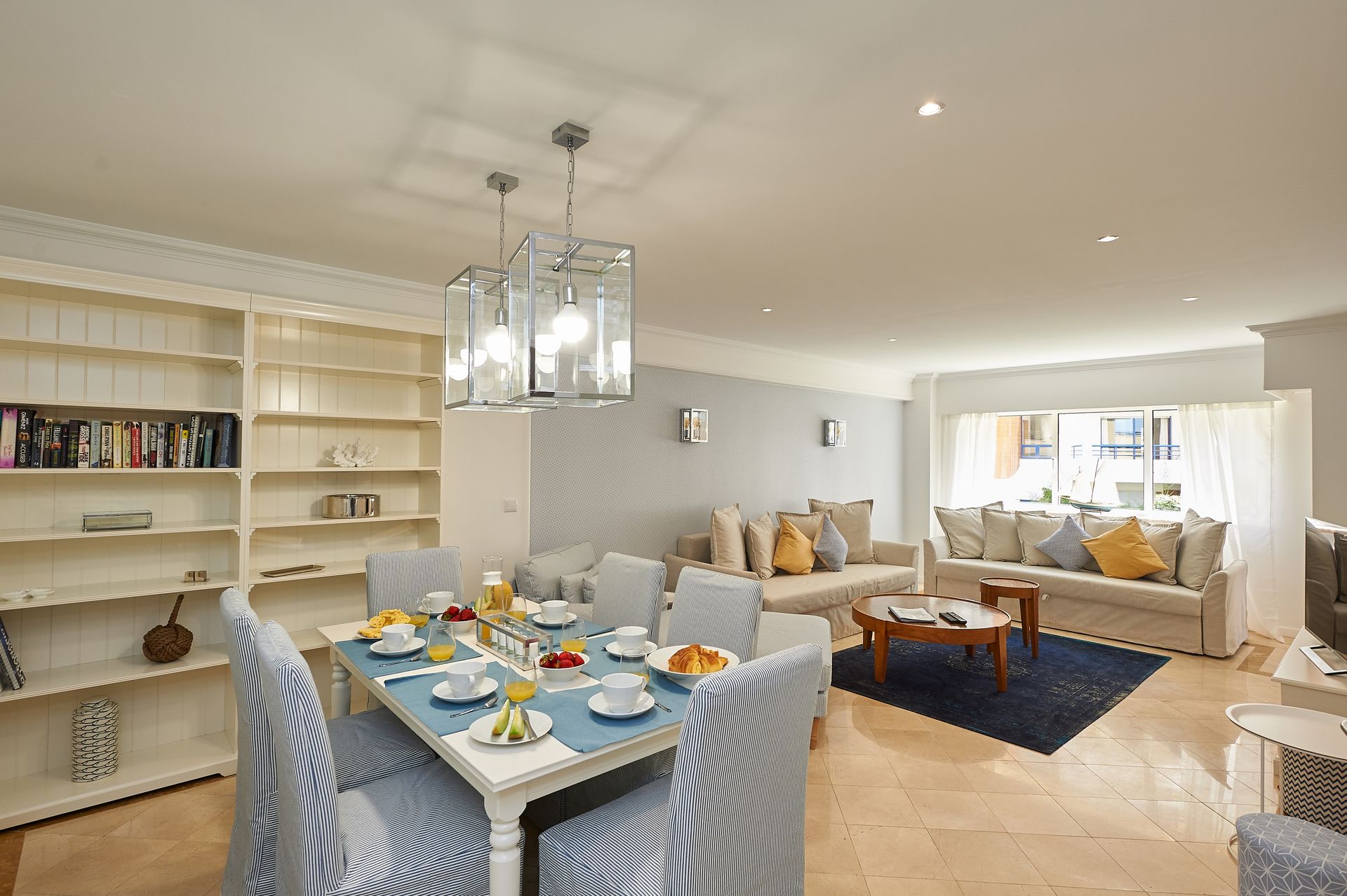 A living room with a dining table and chairs and a couch.