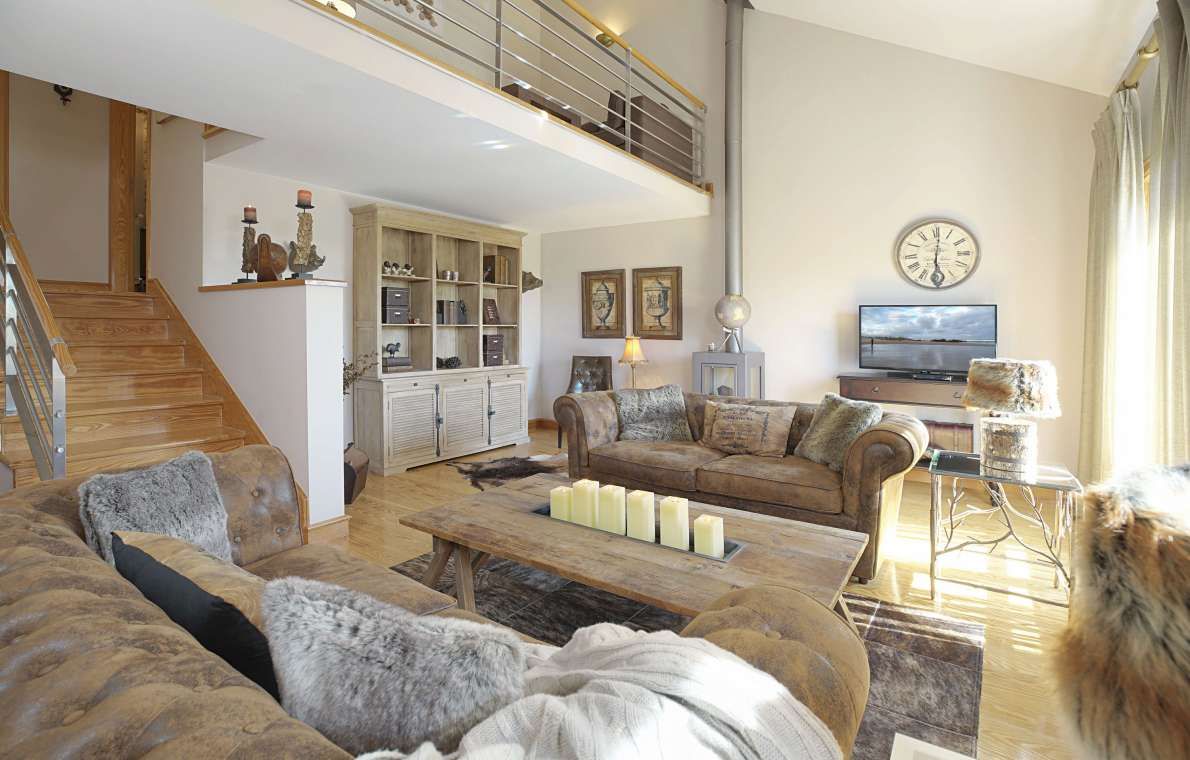 A living room filled with furniture and a clock on the wall.