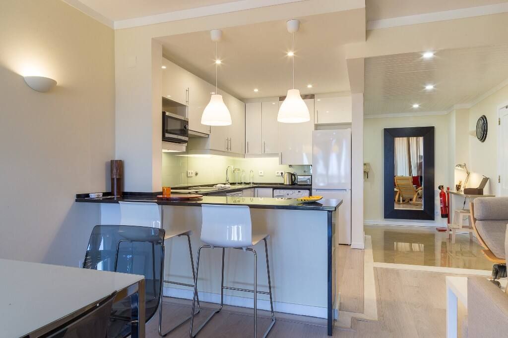 A kitchen with a table and chairs in it