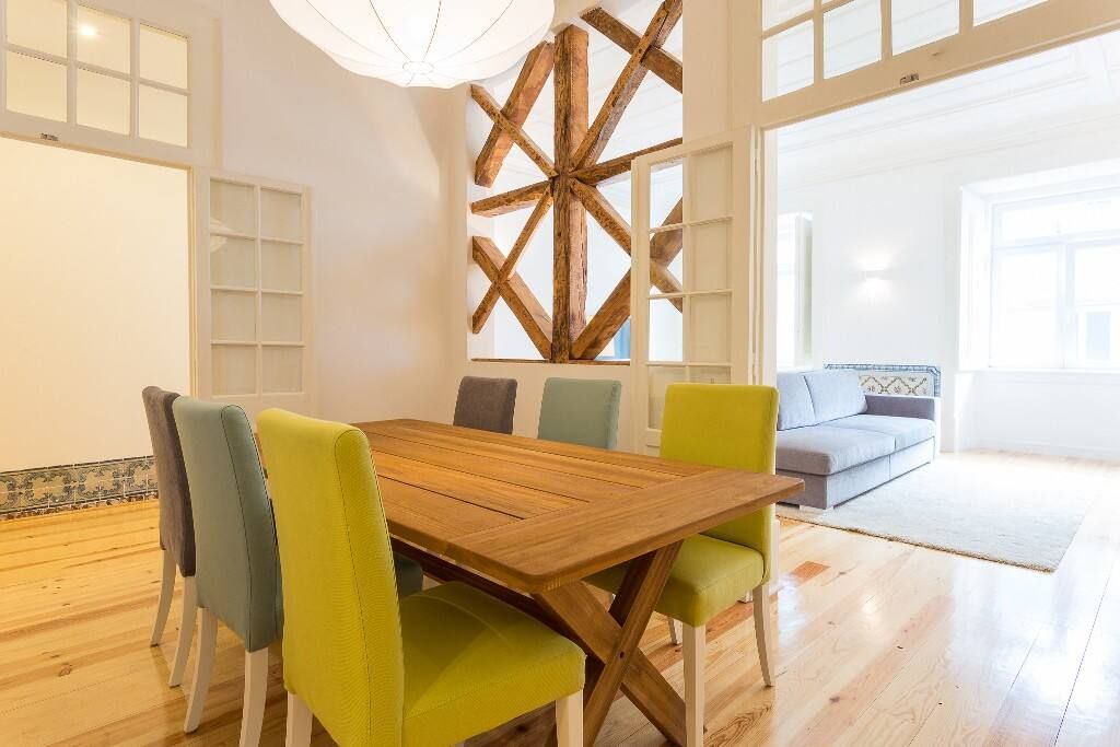 A dining room with a wooden table and colorful chairs