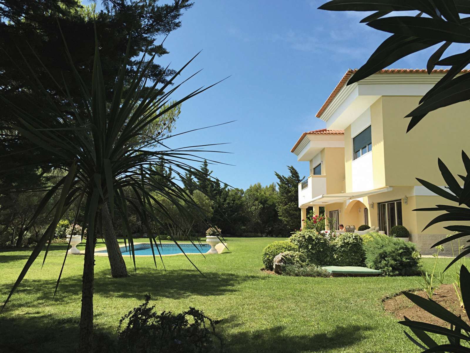 A large house with a swimming pool in the backyard