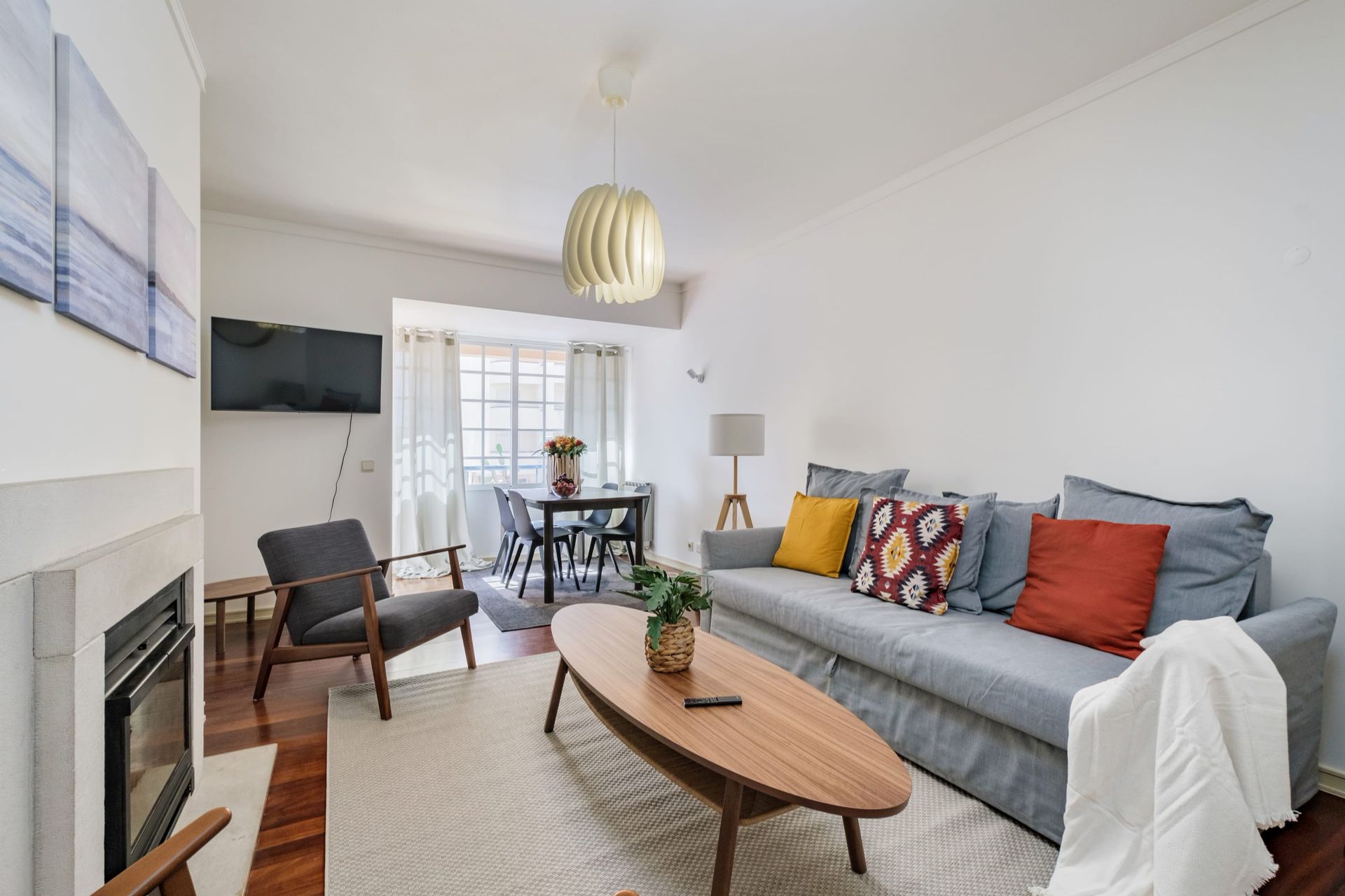 A living room with a couch , chairs , coffee table and fireplace.