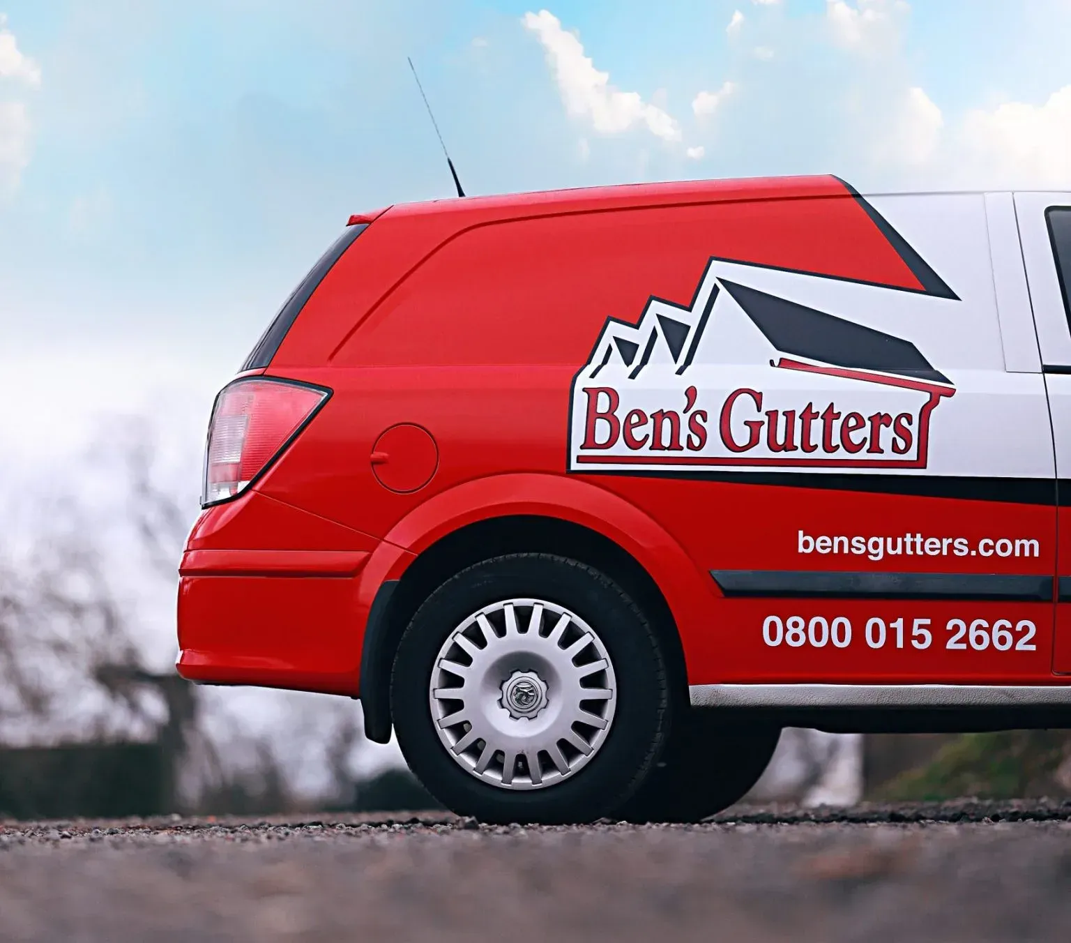 Red van with Ben’s Gutters logo and contact details parked outdoors.