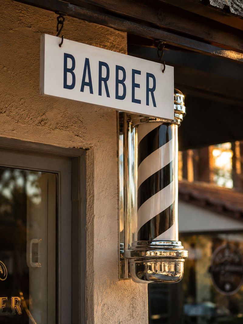 Barber sign and striped pole outside the shop