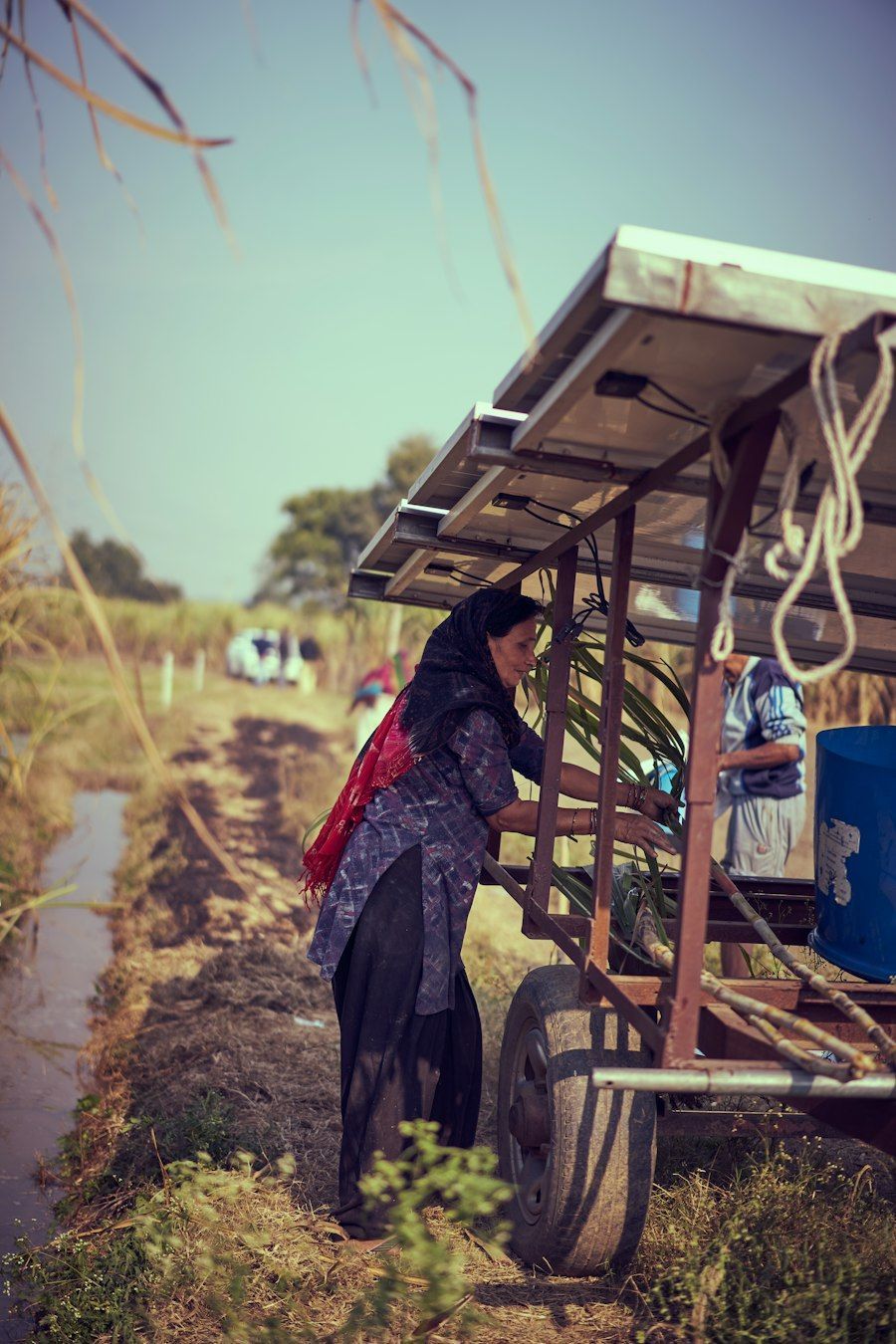A villager at a newly roofed grid shelter