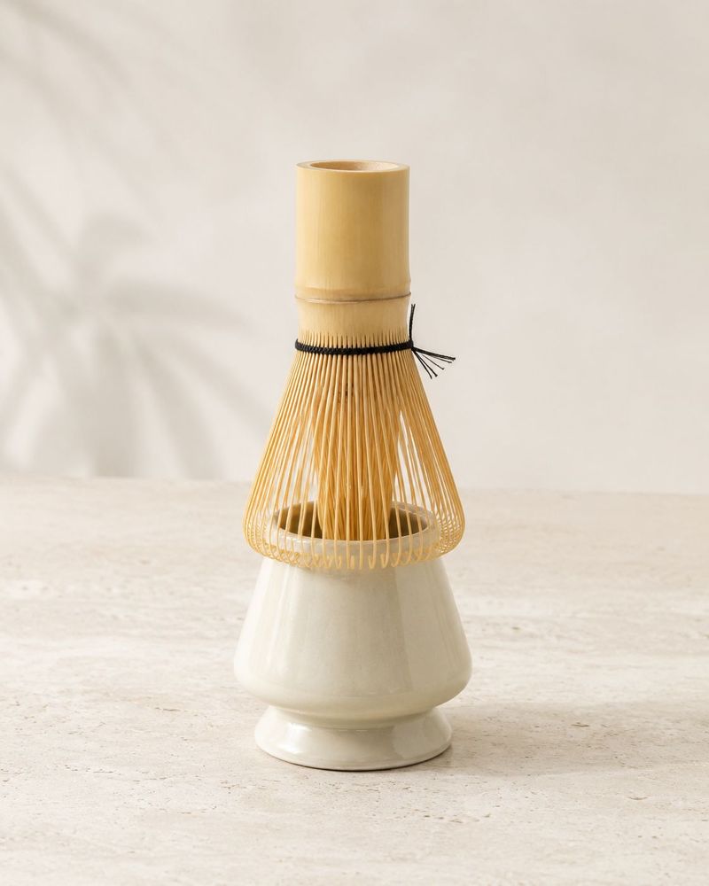 Bamboo matcha whisk on a ceramic stand