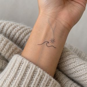 Fine-line wave and sun tattoo on a wrist