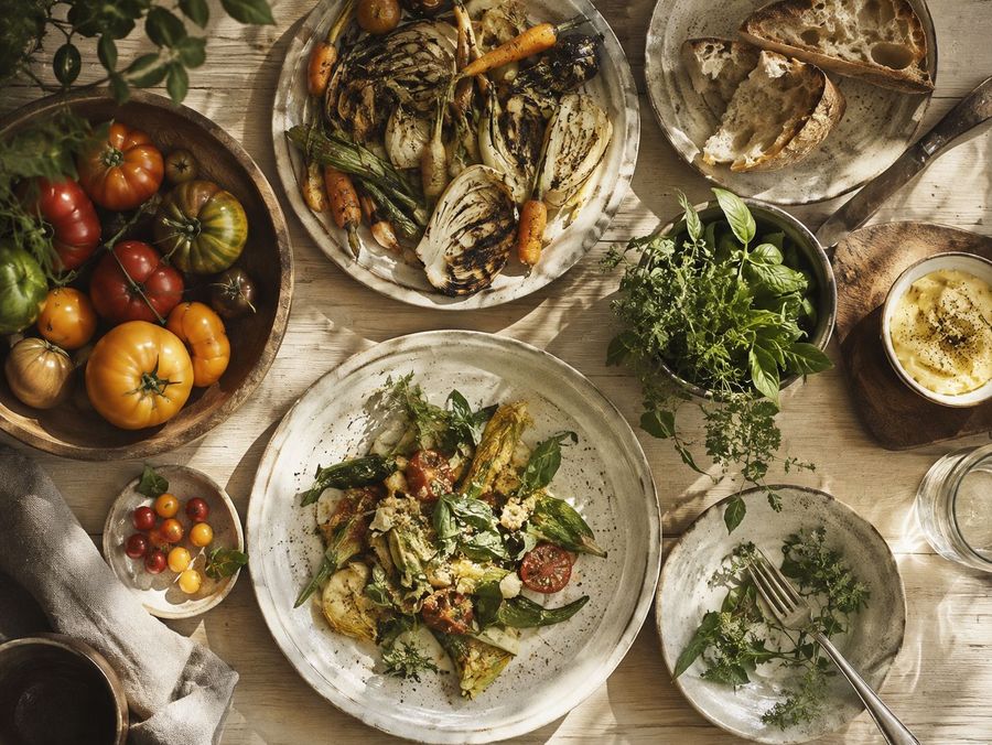 An overhead view of a rustic farm table set for dinner