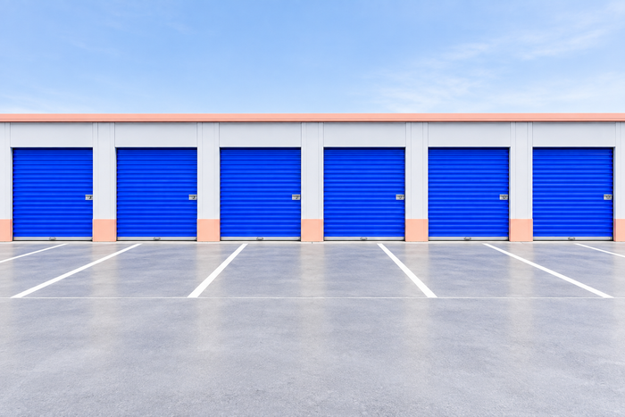 Row of blue roll-up storage doors at the Northgate site
