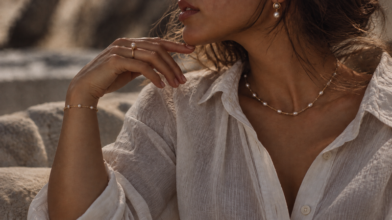 A couple wearing Pearl's 18k gold and freshwater pearl jewellery
