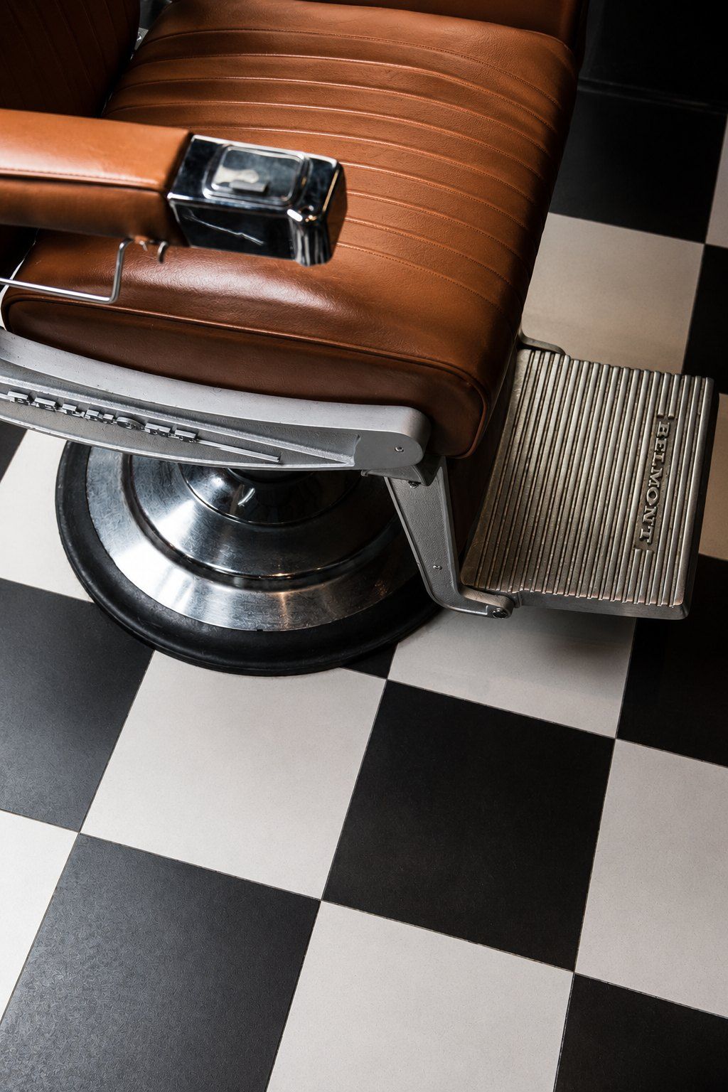 Leather barber chair on a chequered floor