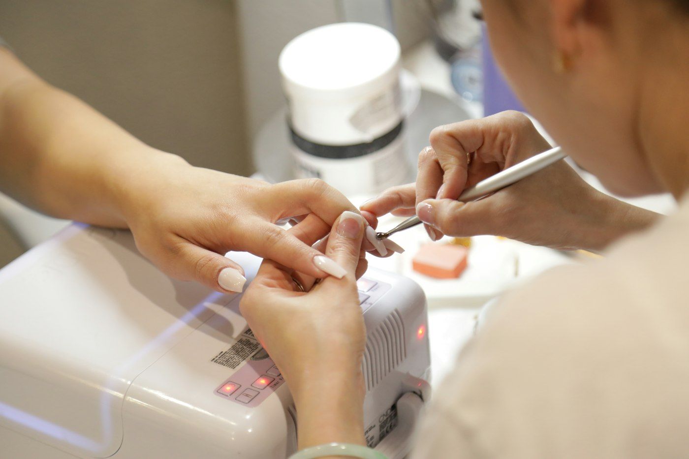 Hands being cared for at the manicure table