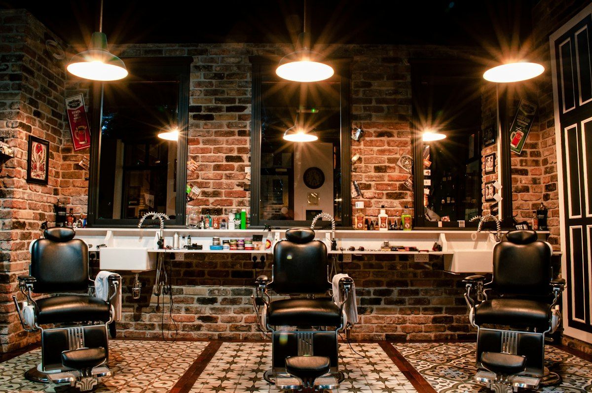 Inside the shop: three chairs under warm lamps